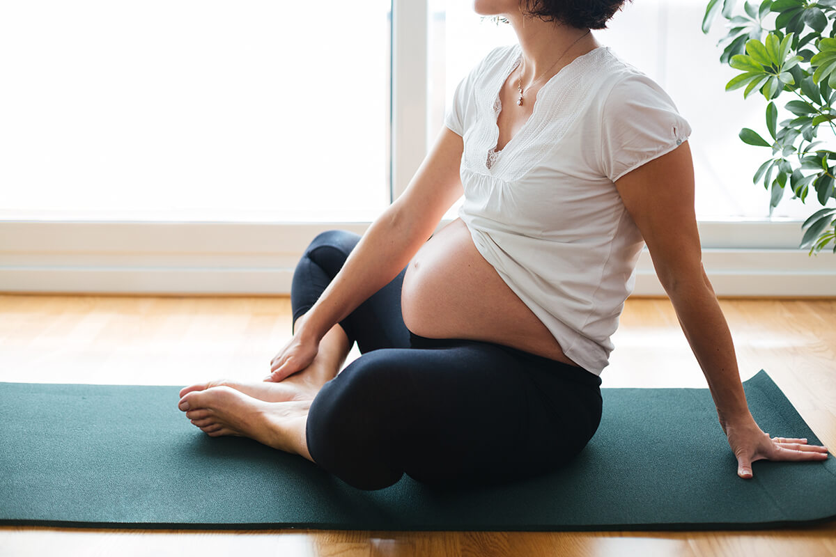 apregnant-woman-sitting-exercise-mat-home (1)